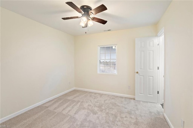 carpeted spare room with ceiling fan