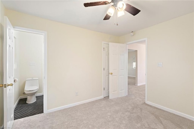 unfurnished bedroom featuring light carpet, connected bathroom, and ceiling fan