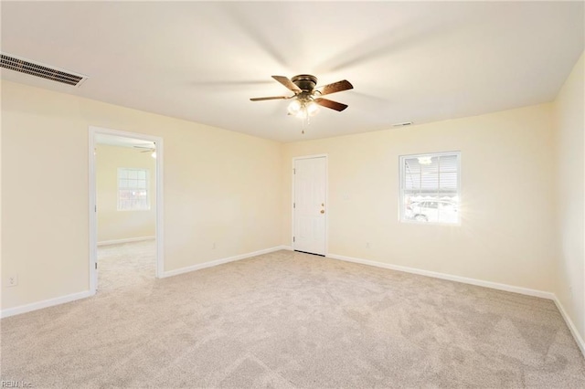 carpeted empty room featuring ceiling fan