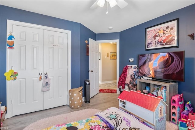 bedroom with ceiling fan, a closet, and light wood-type flooring