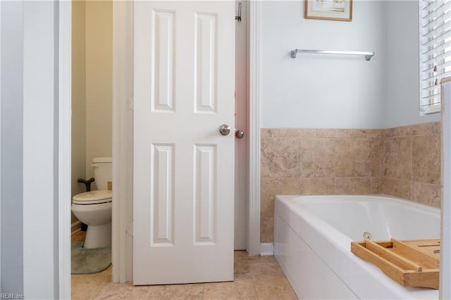 bathroom featuring a bath and toilet