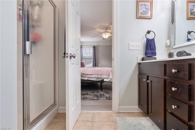 bathroom featuring tile patterned flooring, ceiling fan, walk in shower, and vanity