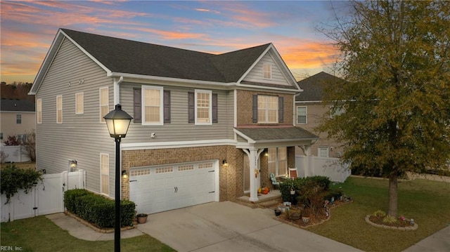 view of front facade featuring a garage and a lawn