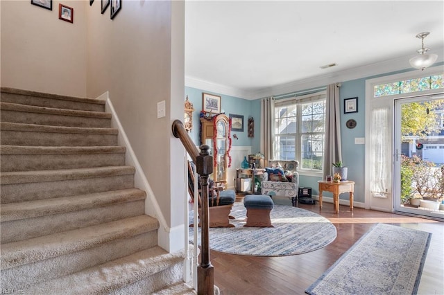 interior space with hardwood / wood-style floors and ornamental molding