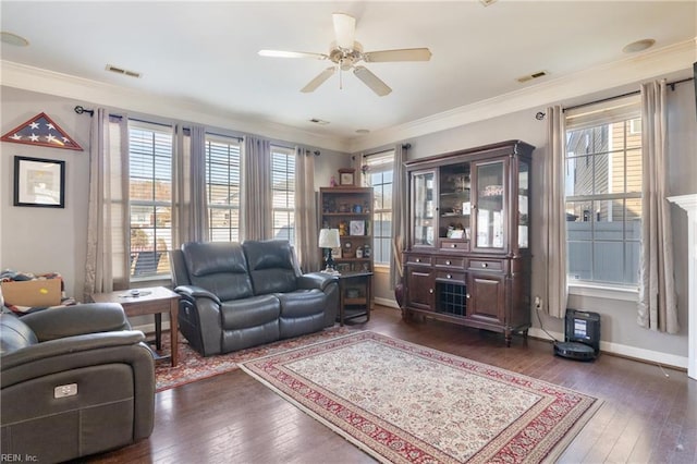 living room featuring ornamental molding, ceiling fan, and dark wood-type flooring