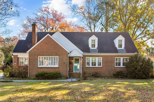 cape cod house with a front yard