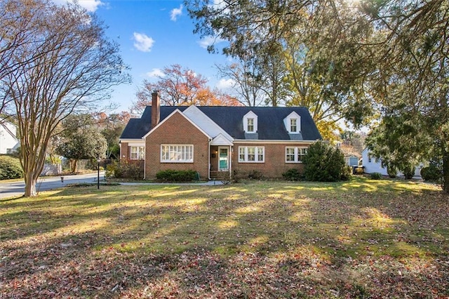 new england style home featuring a front yard