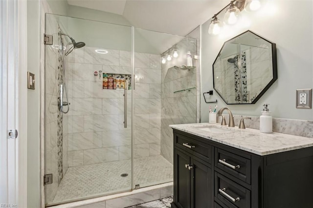 bathroom with vanity, vaulted ceiling, and walk in shower