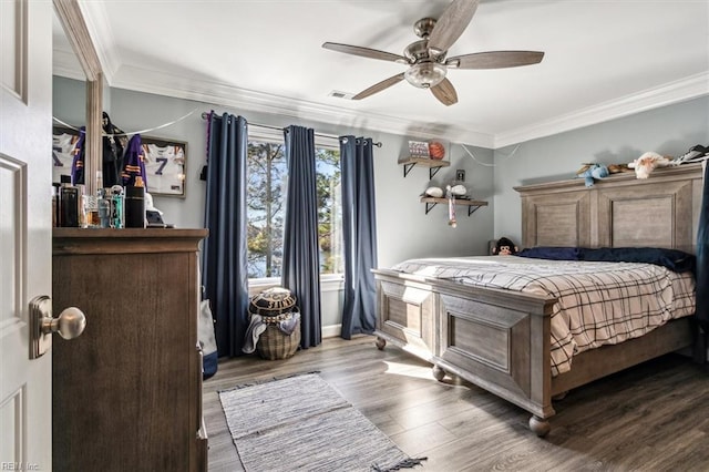 bedroom with hardwood / wood-style flooring, ceiling fan, and ornamental molding