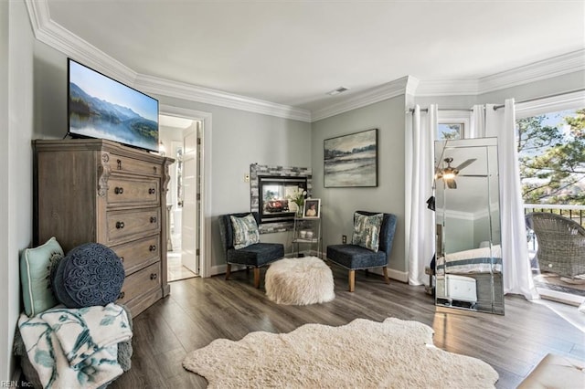 living area with crown molding and dark wood-type flooring