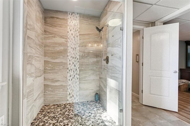 bathroom with hardwood / wood-style floors and tiled shower