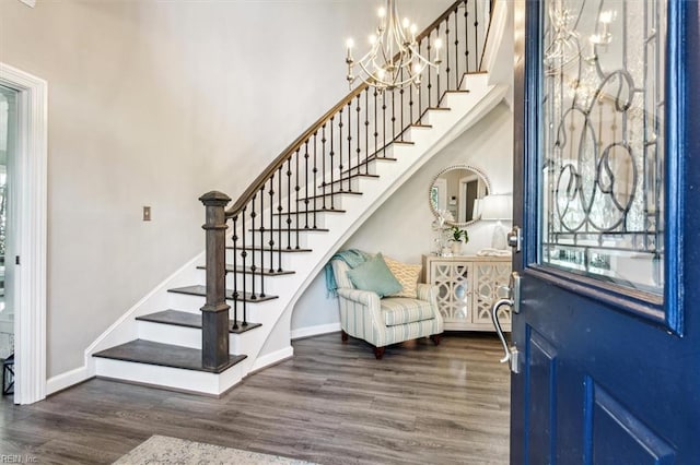 foyer entrance featuring a chandelier and dark wood-type flooring