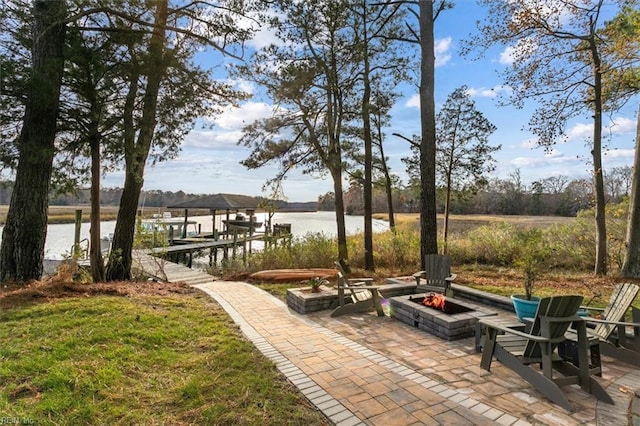 view of patio / terrace with a water view, a dock, and an outdoor fire pit