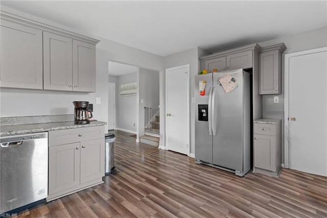 kitchen featuring gray cabinetry, dark wood-type flooring, and appliances with stainless steel finishes