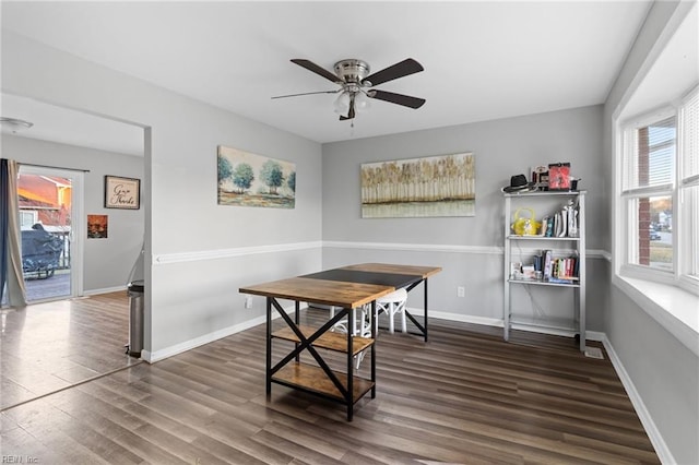 dining room featuring ceiling fan, a healthy amount of sunlight, and dark hardwood / wood-style flooring