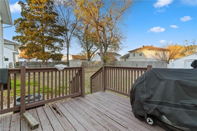 wooden deck featuring area for grilling and a lawn