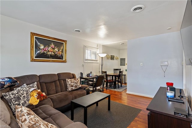 living room with hardwood / wood-style floors and electric panel