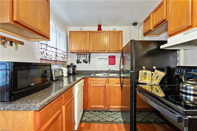 kitchen with white dishwasher, hardwood / wood-style flooring, range with electric stovetop, and sink