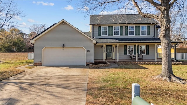 view of front facade with a front yard, a porch, and a garage