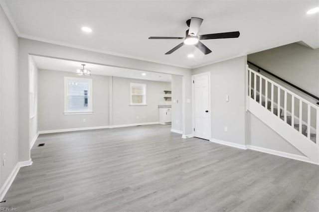 unfurnished living room with crown molding, light hardwood / wood-style flooring, and ceiling fan with notable chandelier