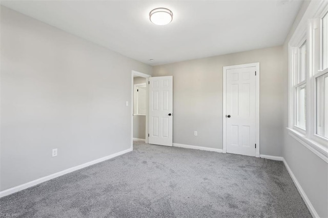 unfurnished bedroom with a closet and carpet floors