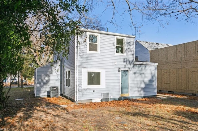 rear view of house featuring central AC unit