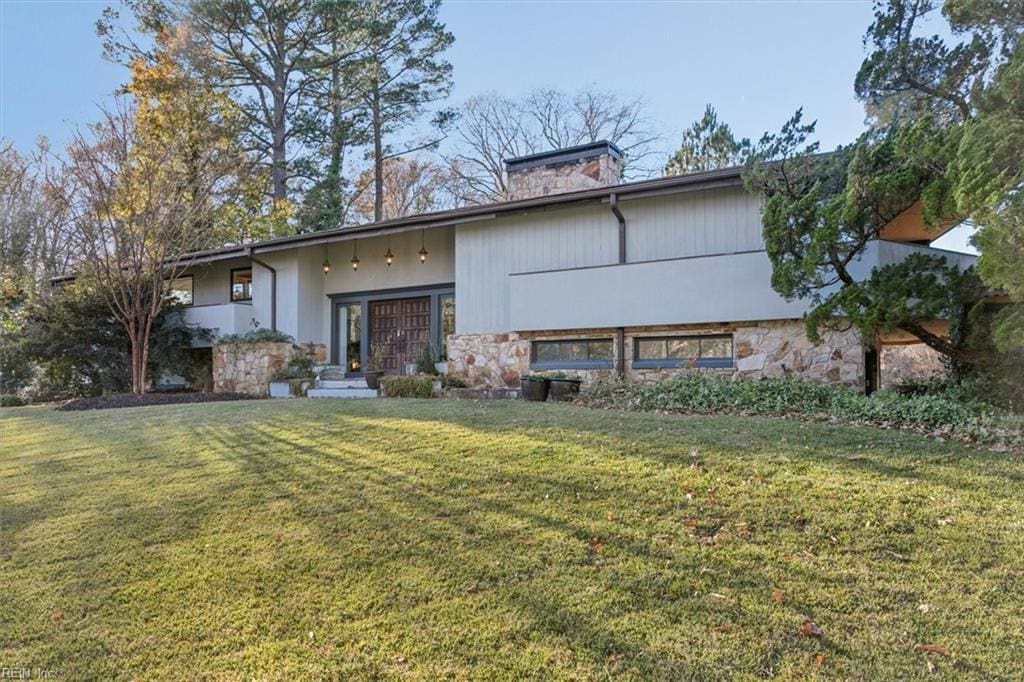 back of property featuring a lawn