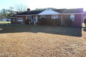 ranch-style home featuring a front yard