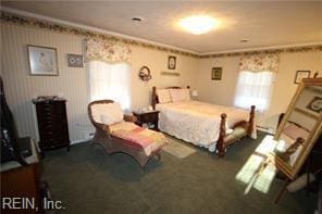 carpeted bedroom with ornamental molding