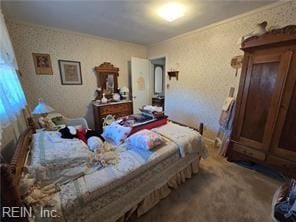 bedroom with carpet floors and crown molding