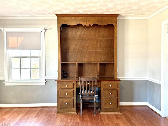 unfurnished office with crown molding and wood-type flooring