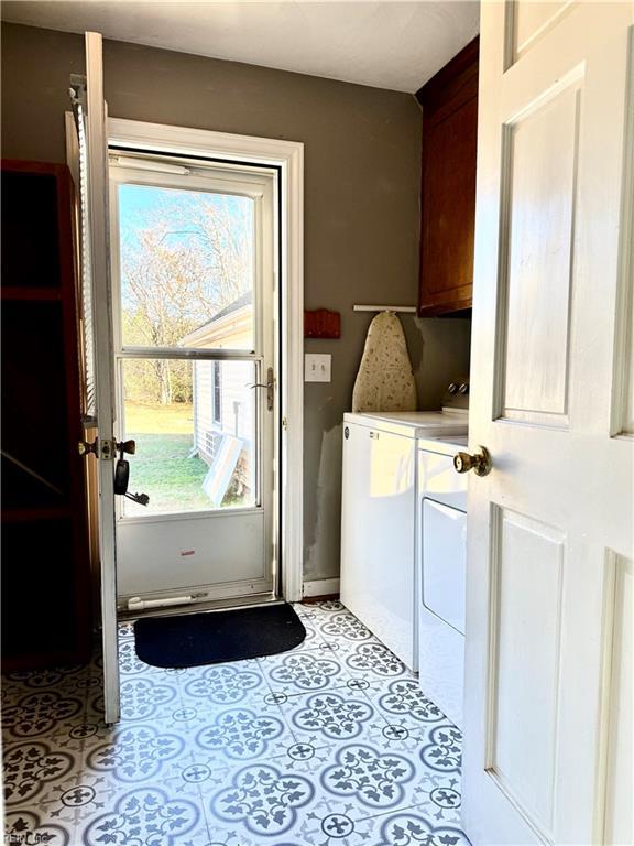 washroom with separate washer and dryer and cabinets