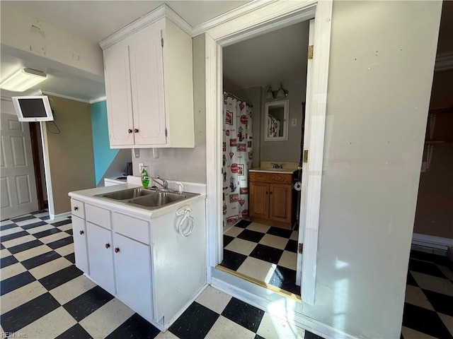 kitchen with white cabinetry and sink