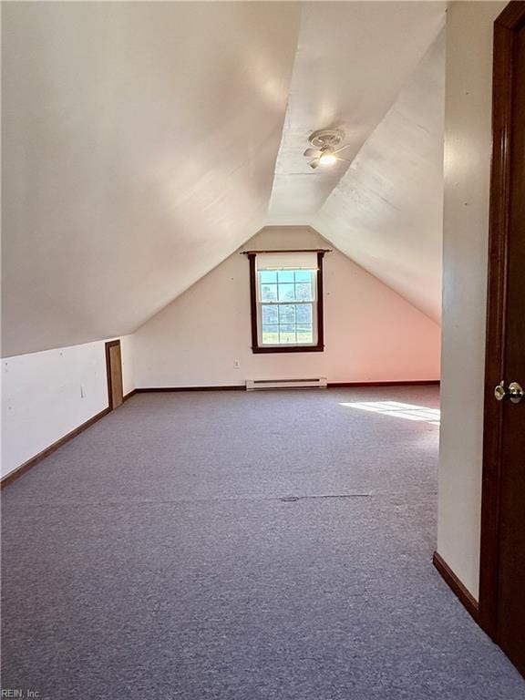 additional living space with baseboard heating, carpet flooring, and vaulted ceiling