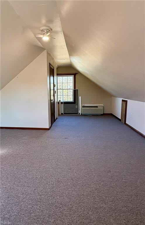 bonus room featuring carpet floors, an AC wall unit, and lofted ceiling