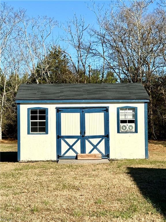 view of outbuilding featuring a yard