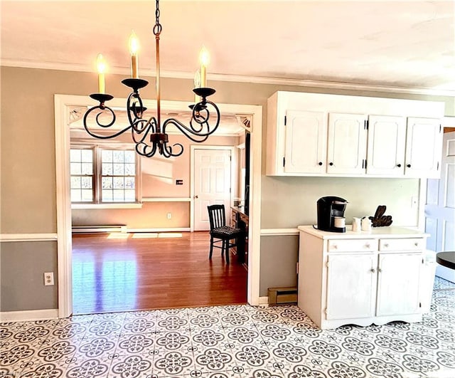 kitchen with pendant lighting, white cabinets, crown molding, light wood-type flooring, and a notable chandelier