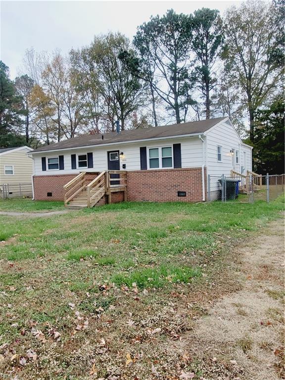 view of front of house with a front lawn and cooling unit