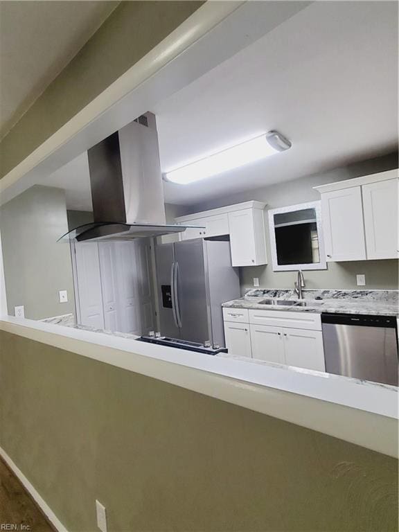 kitchen with island range hood, white cabinetry, sink, and appliances with stainless steel finishes