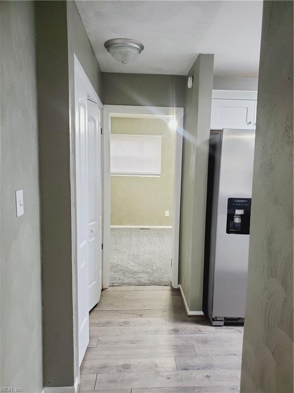 hallway with light wood-type flooring