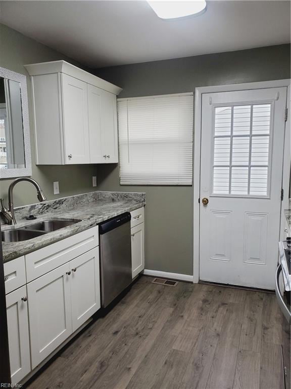 kitchen with white cabinetry, sink, stainless steel appliances, and dark hardwood / wood-style floors