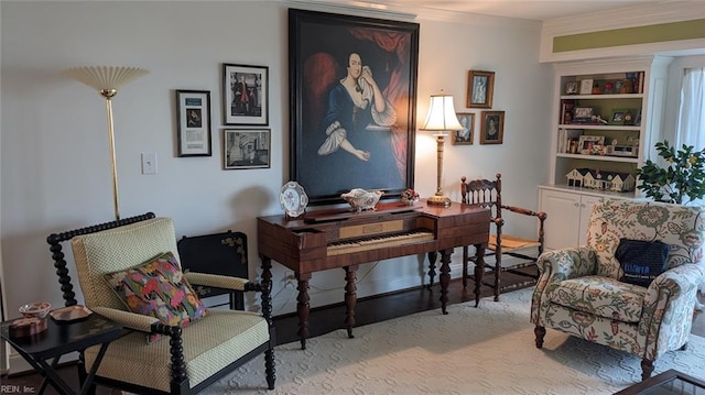 living area featuring light wood-type flooring and ornamental molding