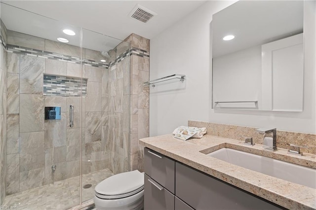 bathroom with vanity, toilet, and walk in shower