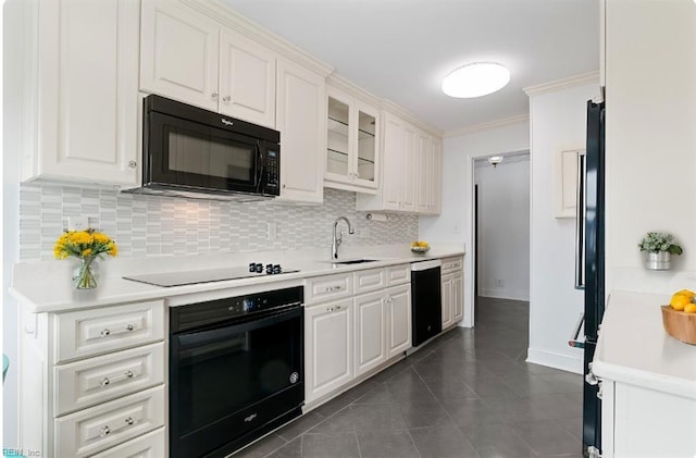 kitchen featuring black appliances, white cabinets, sink, and tasteful backsplash