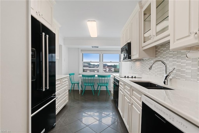 kitchen featuring white cabinetry, sink, backsplash, black appliances, and ornamental molding