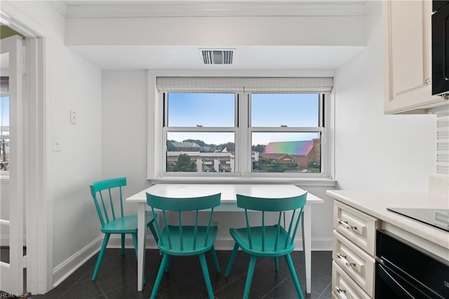 tiled dining room with ornamental molding