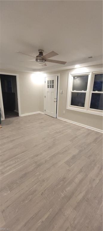 spare room featuring ceiling fan and light hardwood / wood-style floors