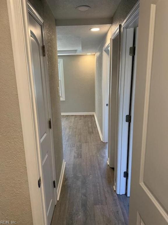 hallway with dark hardwood / wood-style flooring