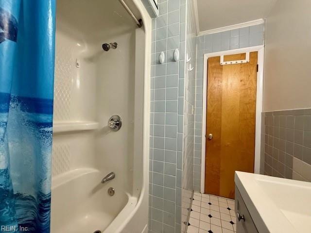 bathroom featuring vanity, crown molding, tile walls, and shower / tub combo with curtain