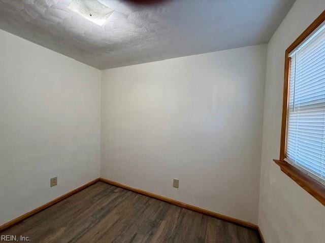 spare room featuring dark hardwood / wood-style flooring